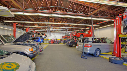 Cars being worked on in the shop at A+ Japanese Auto Repair in San Carlos, CA